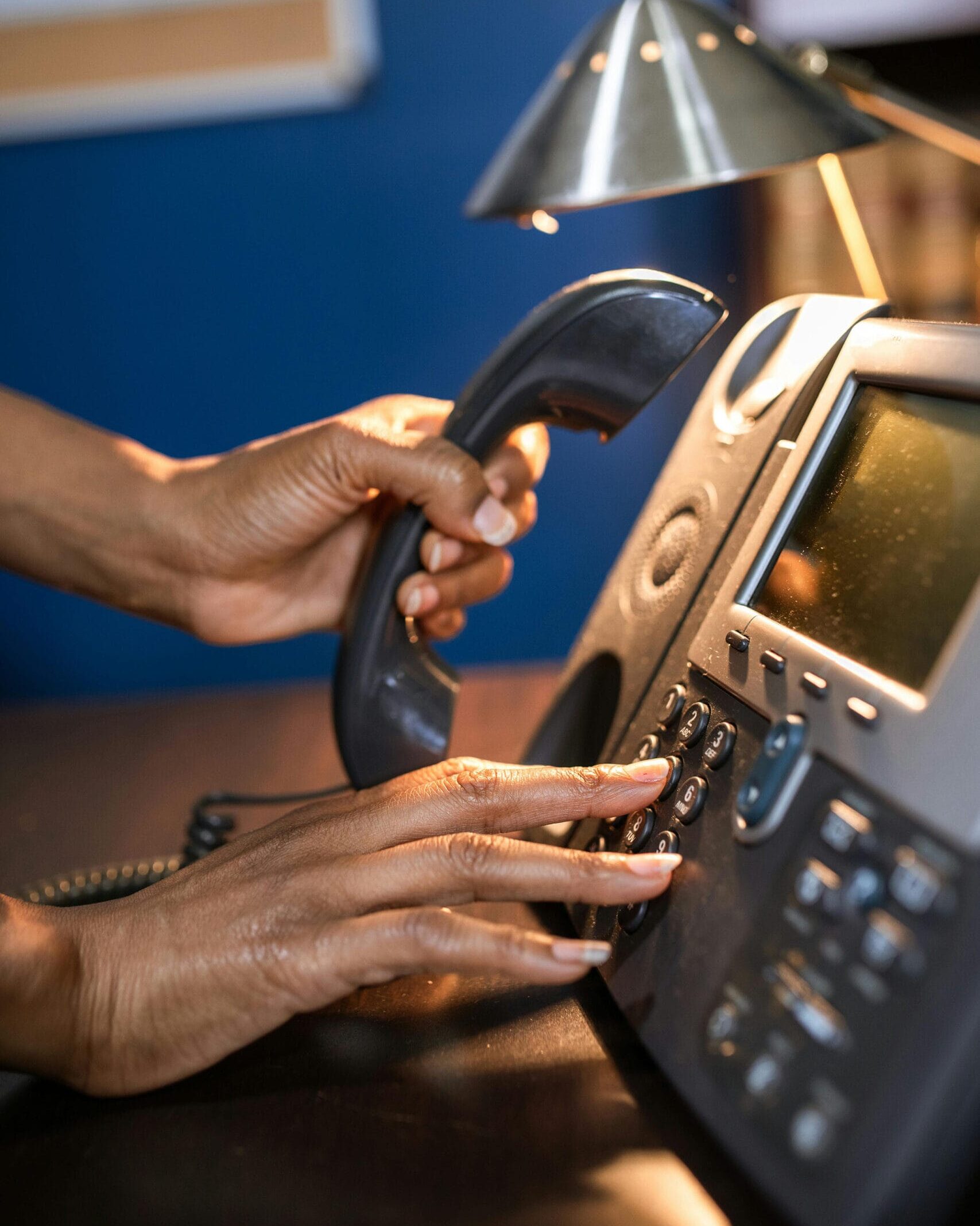 old office phone held in hand