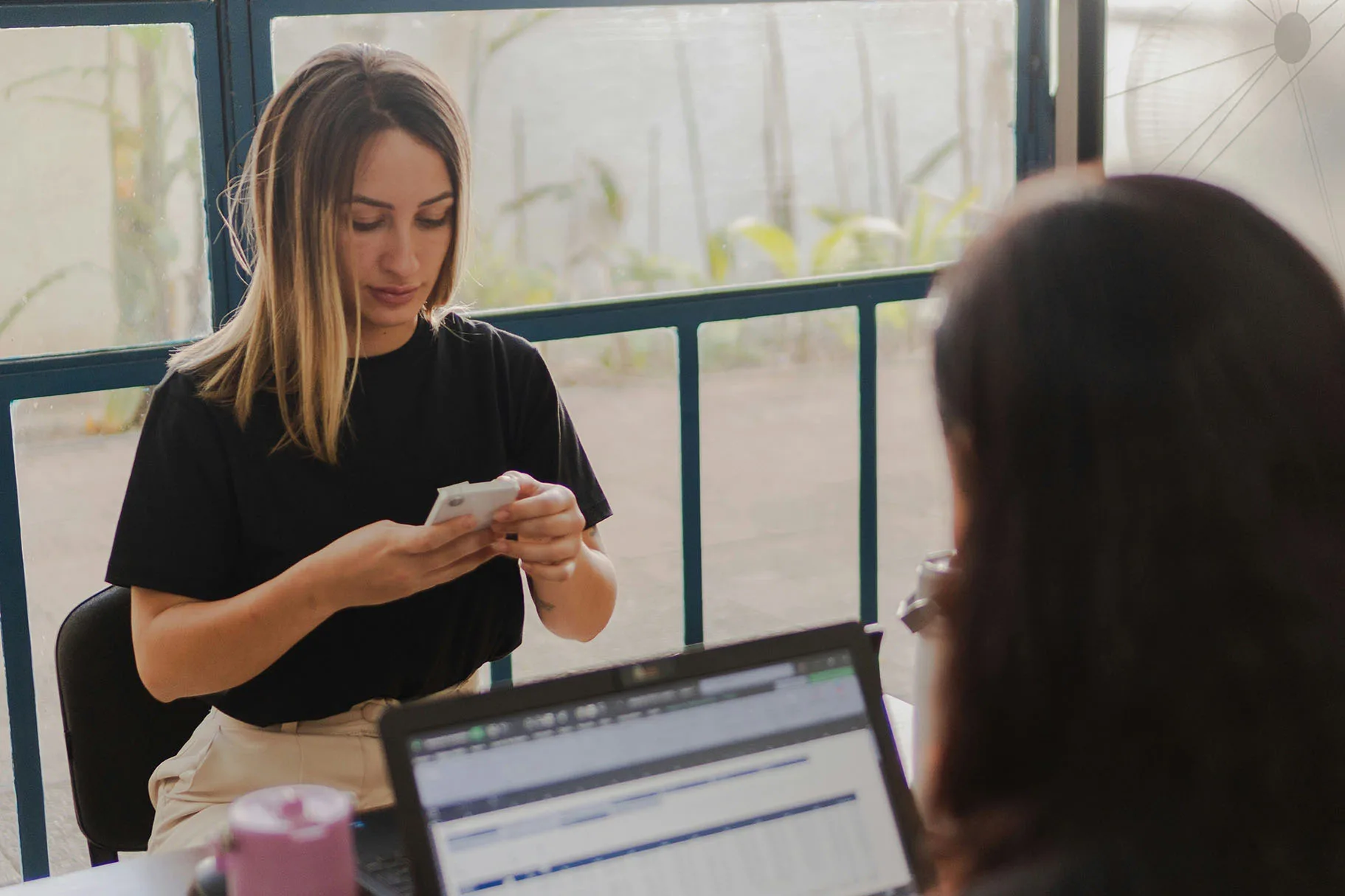 woman on mobile phone for communications in office
